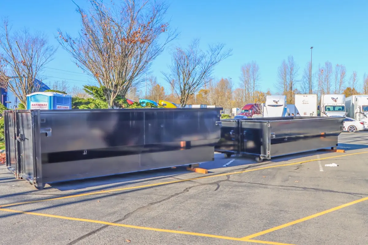 Professional dumpster rental service with roll-off container on residential driveway in Niskayuna